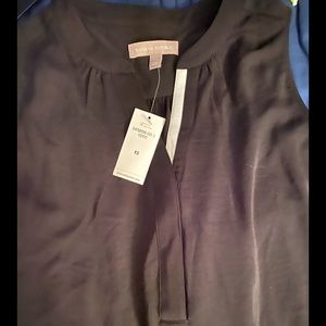 Black sleeveless top with white collar lining